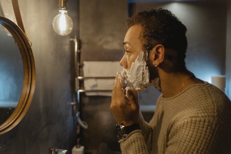 Man shaving in the mirror