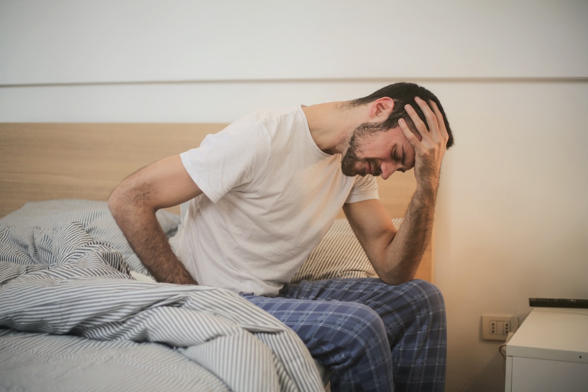 a man in bed looking sick