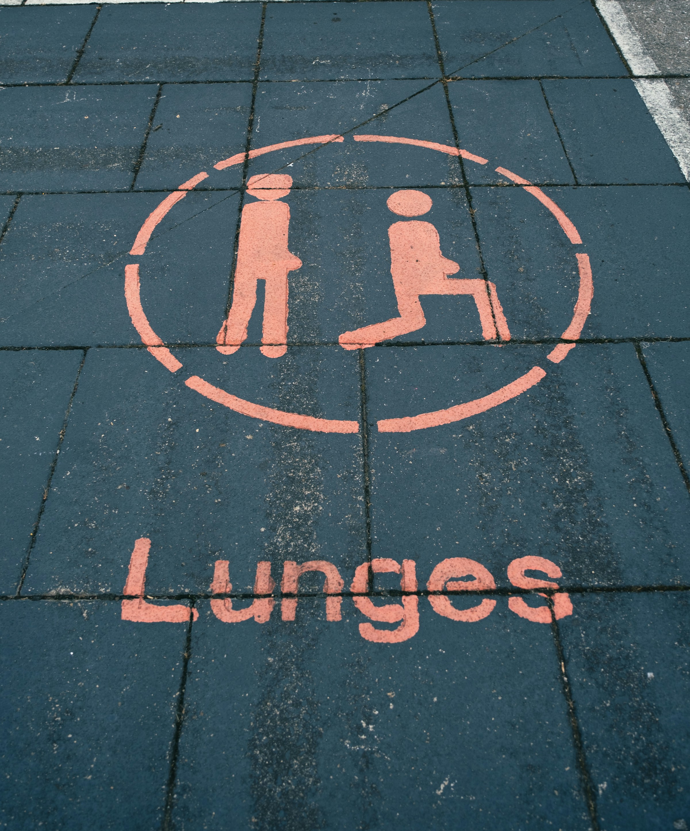 sign on ground in red saying lunges with illustration